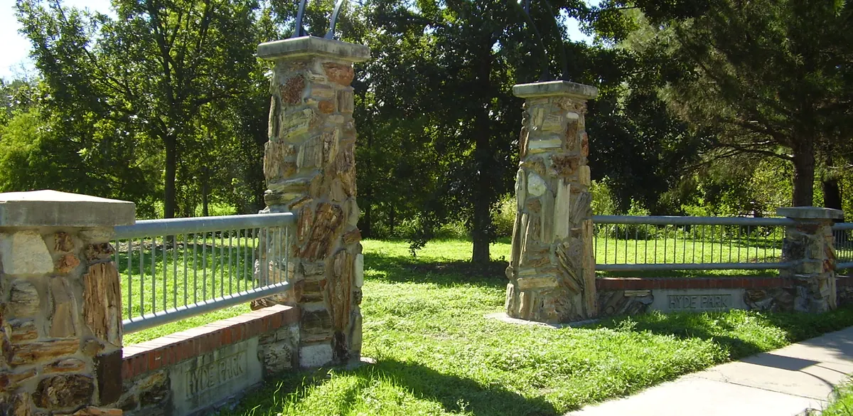 Stone entrance gate and trees at Shipe Park in the Hyde Park neighborhood of Austin.
