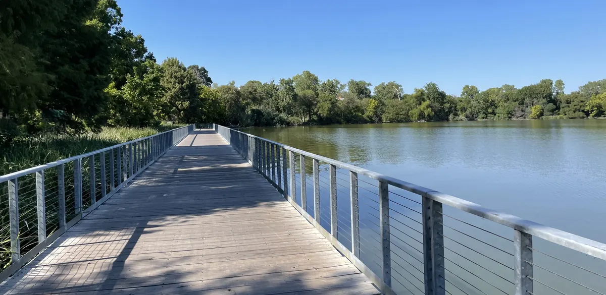 A wooden boardwalk beside White Rock Lake in Dallas.